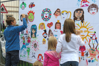 "Gesichter für ein friedliches Miteinander" - Kunstaktion bei Fluss mit Flair mit der Arbeitsloseninitiative Gießen